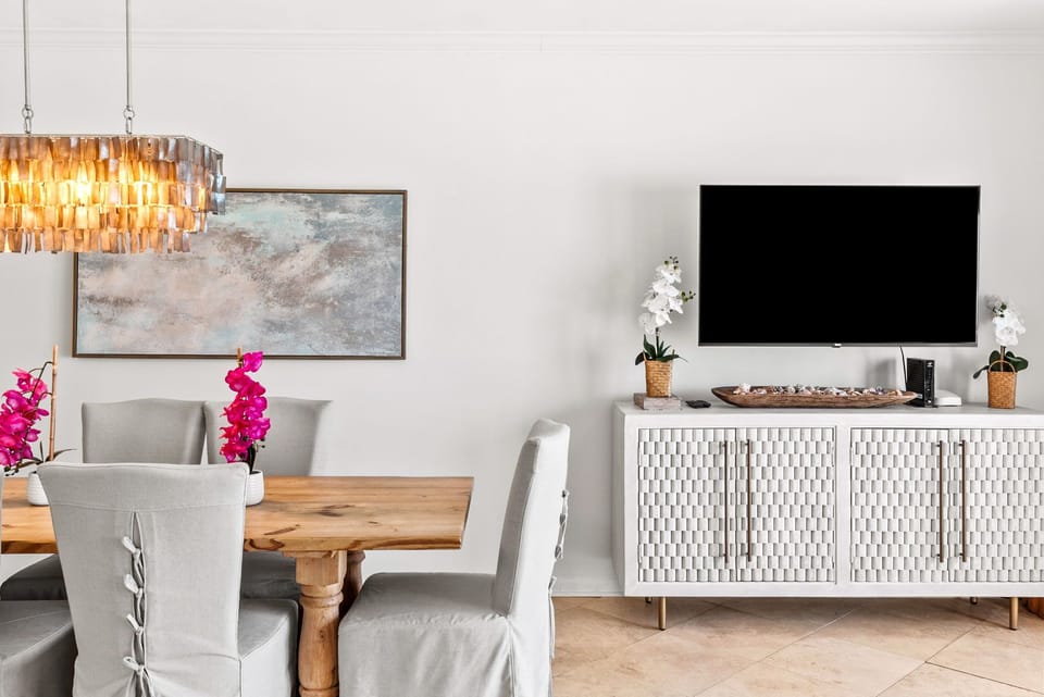 Gulf front living with 55" smart TV and gulf front balcony with panoramic views.