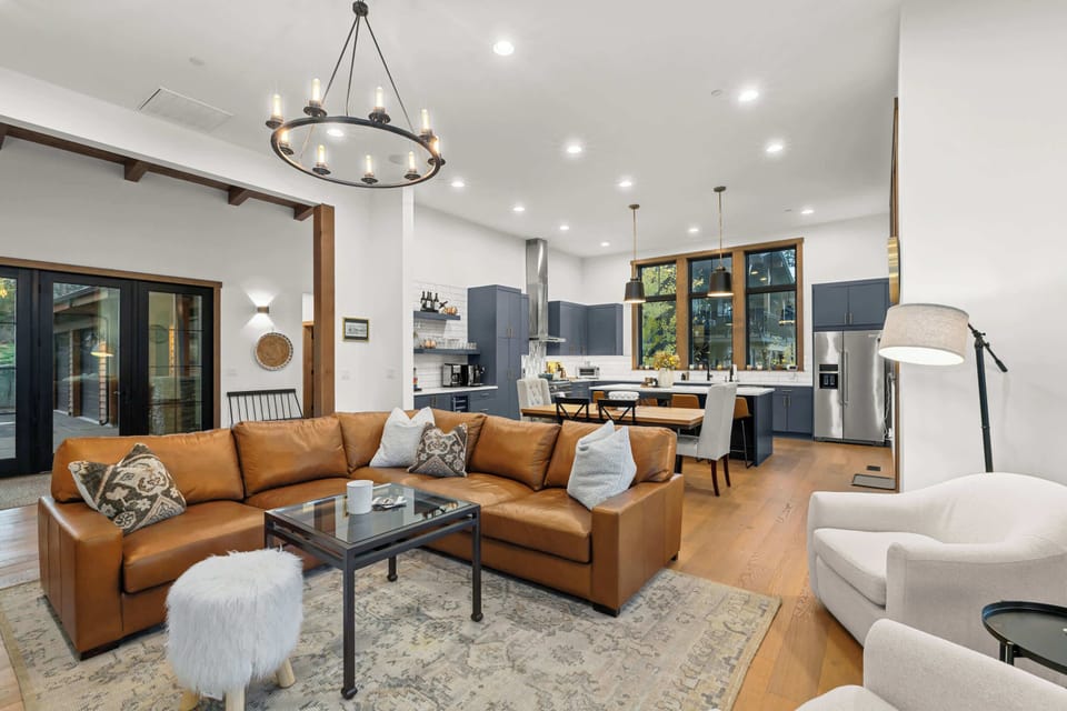 Open-concept great room with comfortable seating, dining area, and chef’s kitchen.
