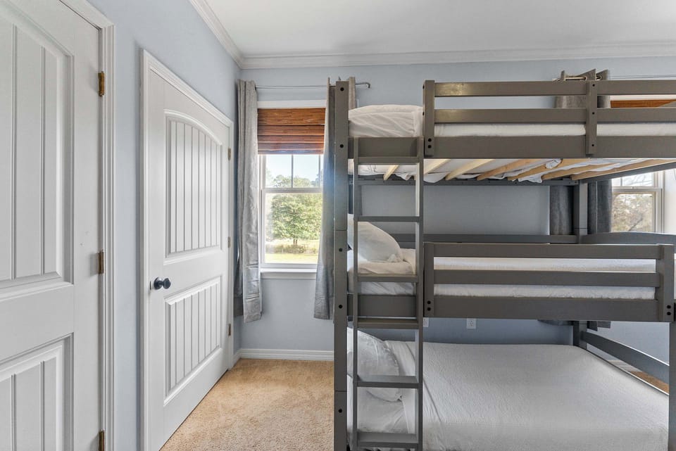 Kid friendly bunk room with triple bunk beds