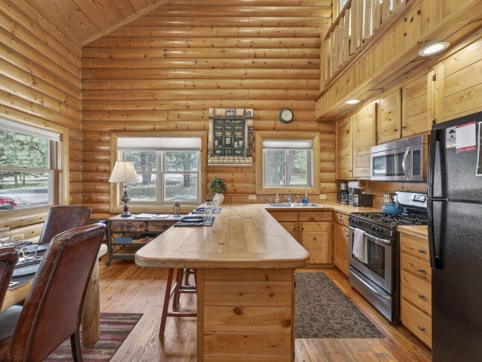 Kitchen | Gas Range & Coffee Maker | Wood Cabinetry & Island Seating