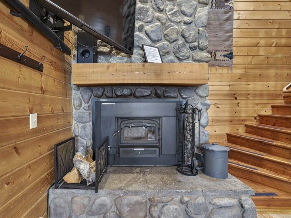 Living Room | Stone Fireplace & Timber Ceilings | Open Dining Space