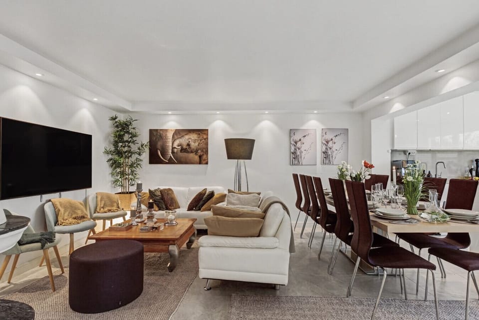 Open-plan living room, dining area, and kitchen designed for comfortable group stays.