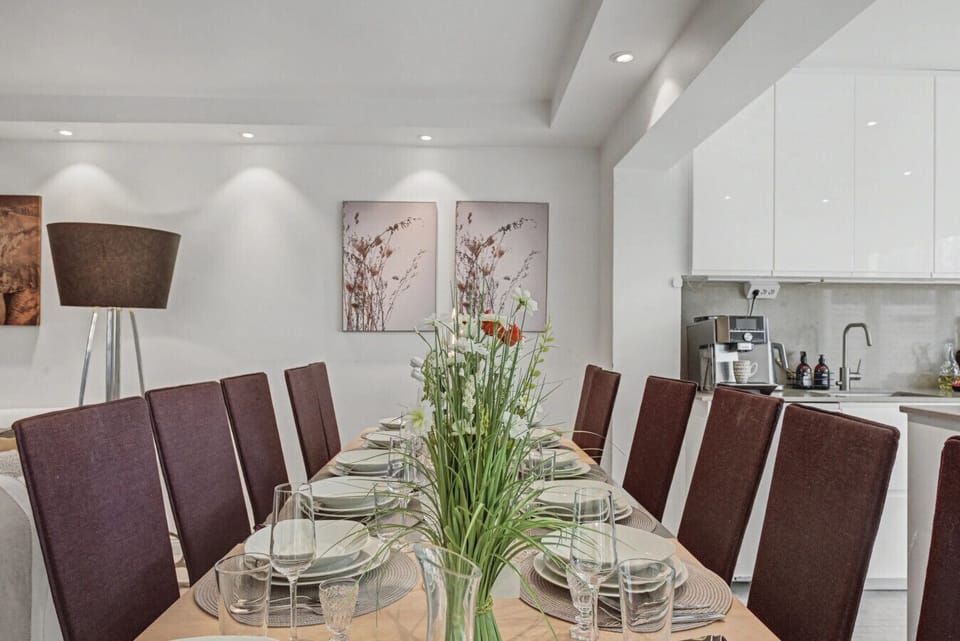 Spacious dining table for group meals located beside the kitchen and living area.