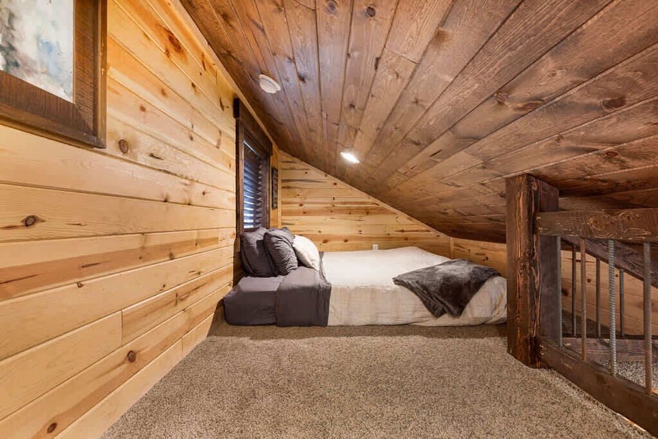 King bed in the open loft area.