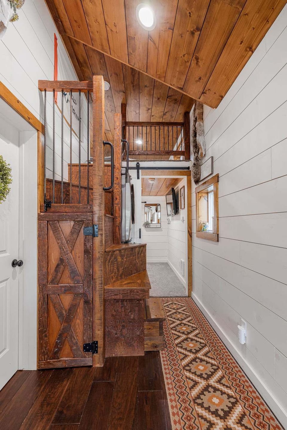 Hallway photo shows the climb in loft and access to the main level bedroom.