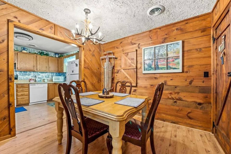 Gather around the cozy dining table surrounded by warm wood walls and rustic cabin charm. It’s the perfect spot to share meals, play games, or plan the next day’s Gatlinburg adventures.