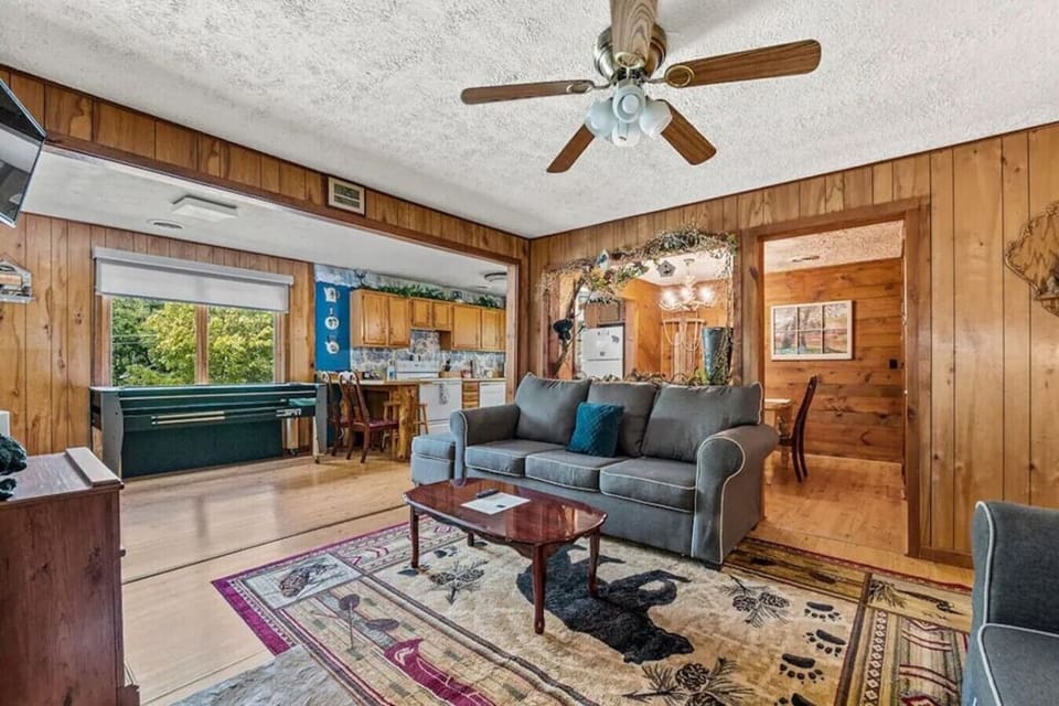 Relax in the comfortable living room while the nearby game table adds a little fun to the space. The open layout keeps everyone connected during your stay.