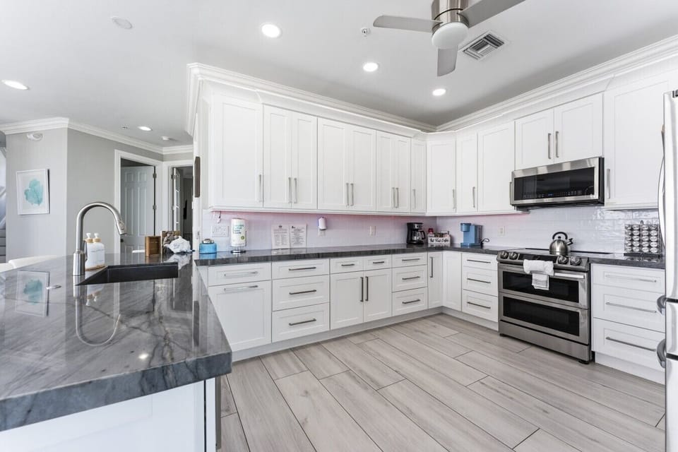 Cook with ease in the spacious kitchen featuring granite countertops, stainless steel appliances, abundant cabinetry, and everything needed for family meals.