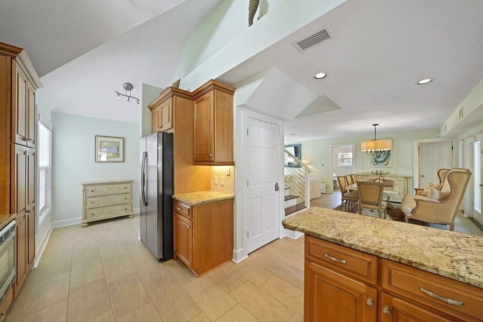 Main House 1st Floor - Gourmet kitchen featuring a premium Thermador gas range, spacious countertops, and everything needed to prepare meals for your group. Perfect for family dinners, entertaining, and gathering after a day at the beach.
