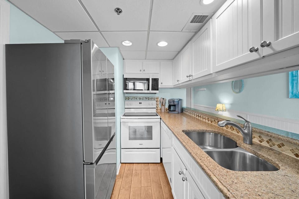 A kitchen with a view! Prep your favorite meals without ever losing sight of the ocean through the pass-through.