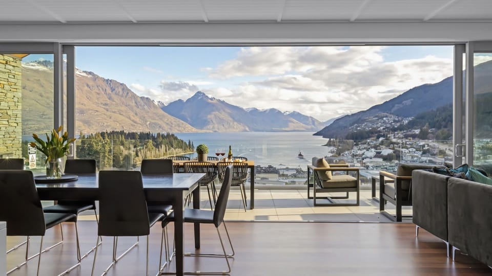 Large living opening to balcony overlooking Queenstown Bay