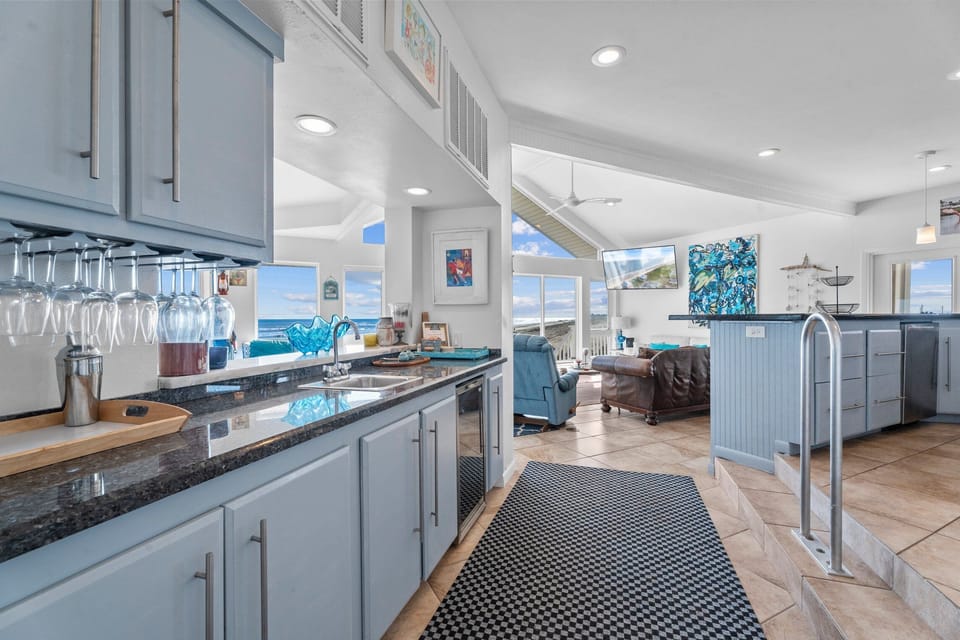 Bright open kitchen with granite countertops and views into the living area.