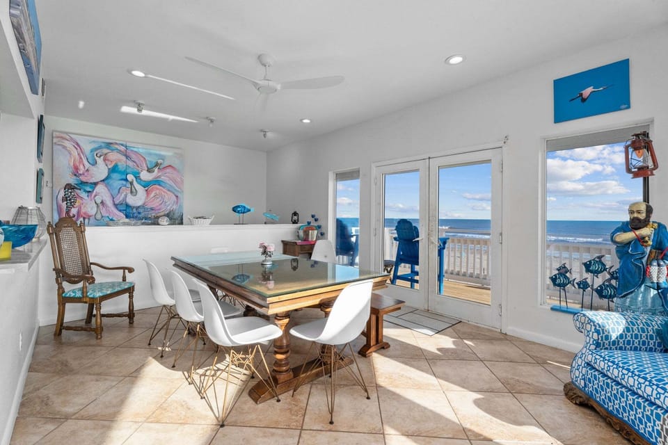 Coastal dining area with natural light and easy access to the oceanview balcony.