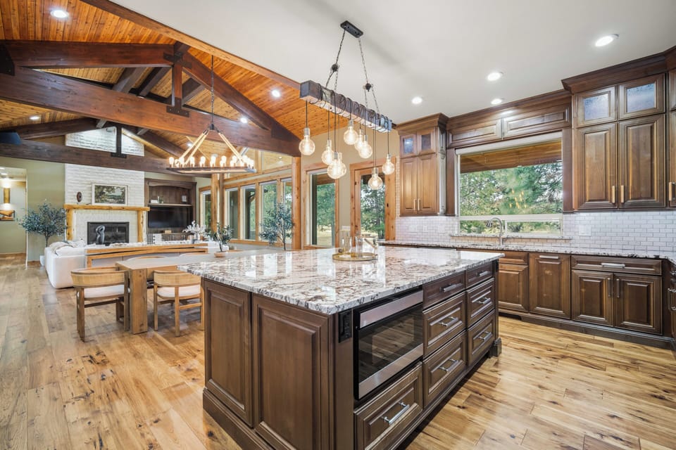 Your spacious gourmet kitchen features rich wood cabinetry and gleaming granite countertops, perfect for preparing memorable meals during your stay.