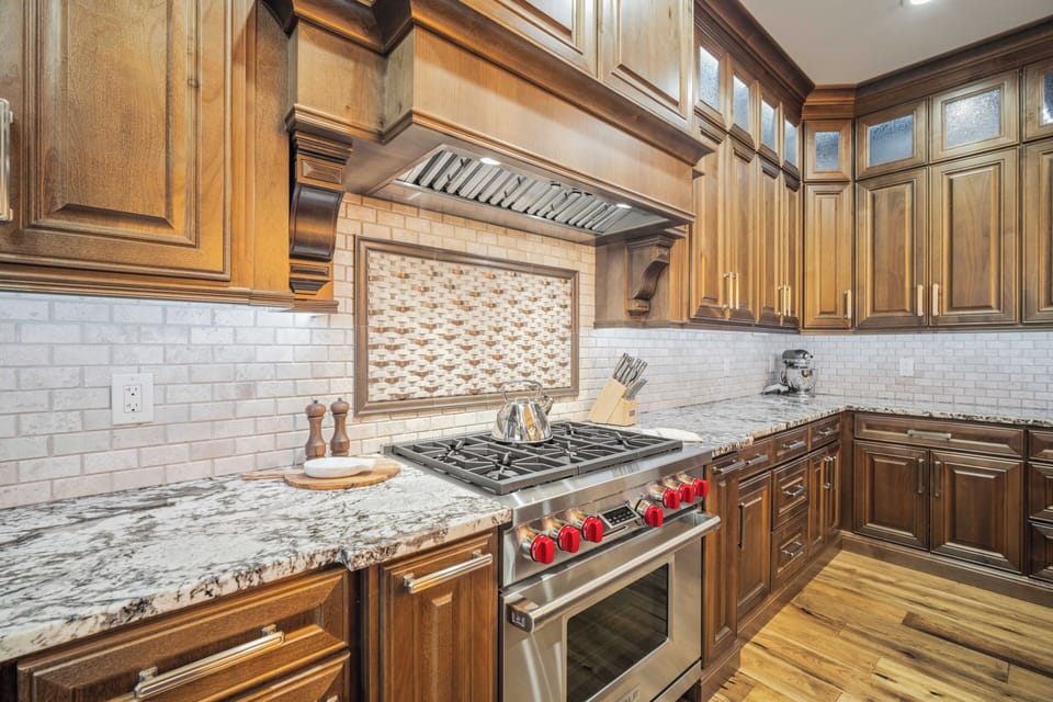Your gourmet kitchen features rich wood cabinetry, granite countertops, and professional-grade stainless steel appliances for memorable culinary experiences.