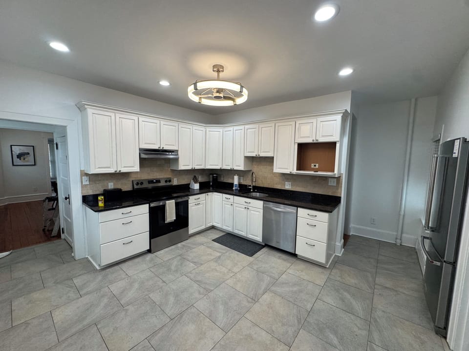 Bright, spacious kitchen stocked with all the essentials for cooking and dining.