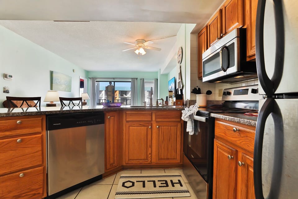 Kitchen area with view of living room and main balcony.