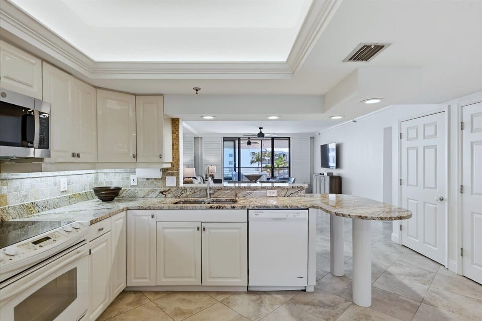 Cook with ease in your fully-equipped kitchen featuring granite counters, modern appliances, and an open layout that flows into the living space.