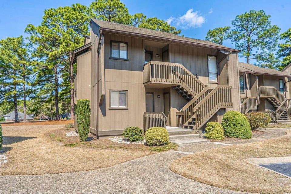 Exterior view of the property with private entrance, outdoor stairs, and peaceful surroundings.