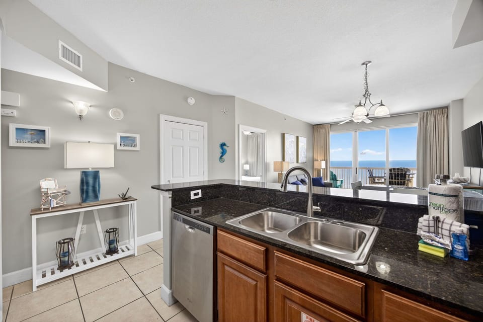 Your fully equipped kitchen features granite counters and ocean views, perfect for preparing meals while enjoying the coastal scenery.
