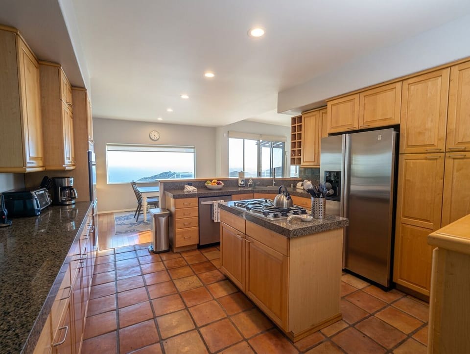 Large chef's kitchen with nook seating, coffee, utensils, dishes ready to cook and serve your family and friends!