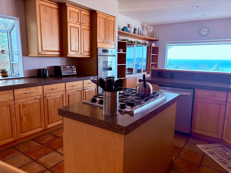 Large chef's kitchen with nook seating, coffee, utensils, dishes ready to cook and serve your family and friends!