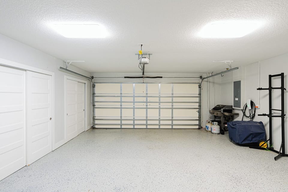 Spacious two-car garage with epoxy flooring provides secure parking and storage space for your vacation rental stay.