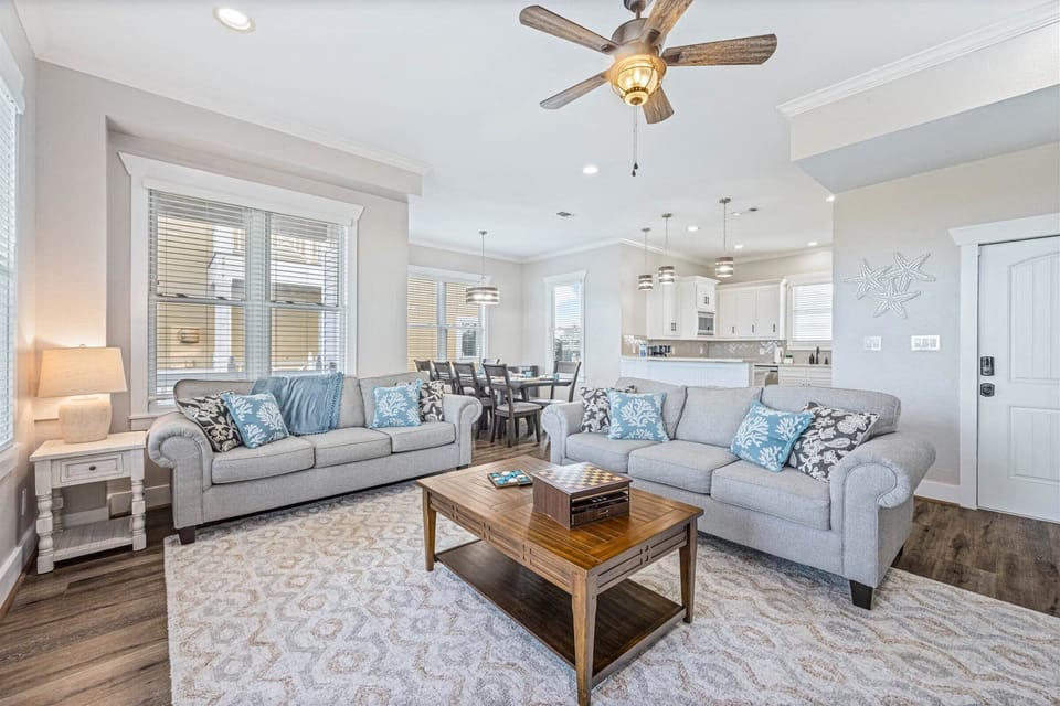 Spacious living area with plush sofas and coastal accents.