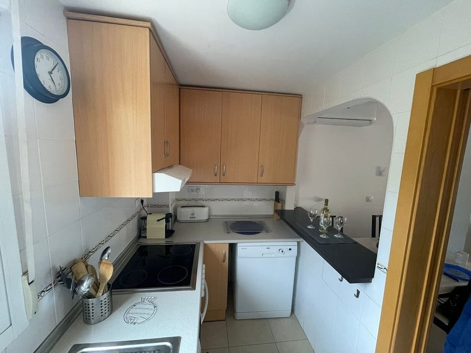 Bright kitchen with ample counter space, storage and Siemens dishwasher