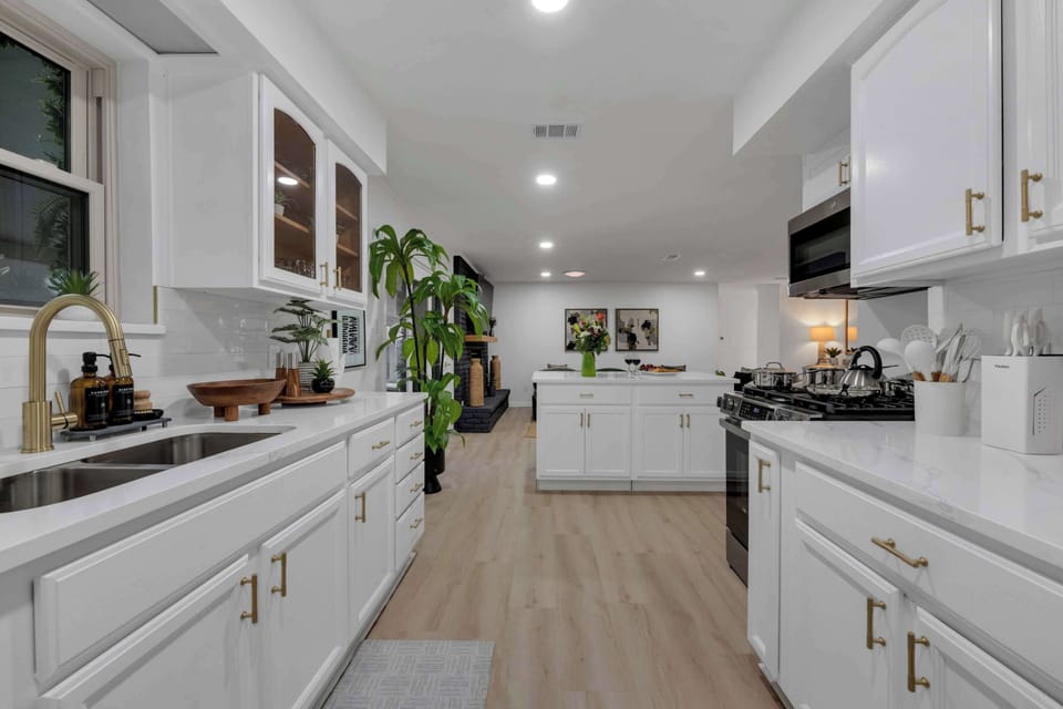 The modern, fully equipped kitchen features stainless steel appliances, spacious countertops, and everything you need to prepare meals for your group.