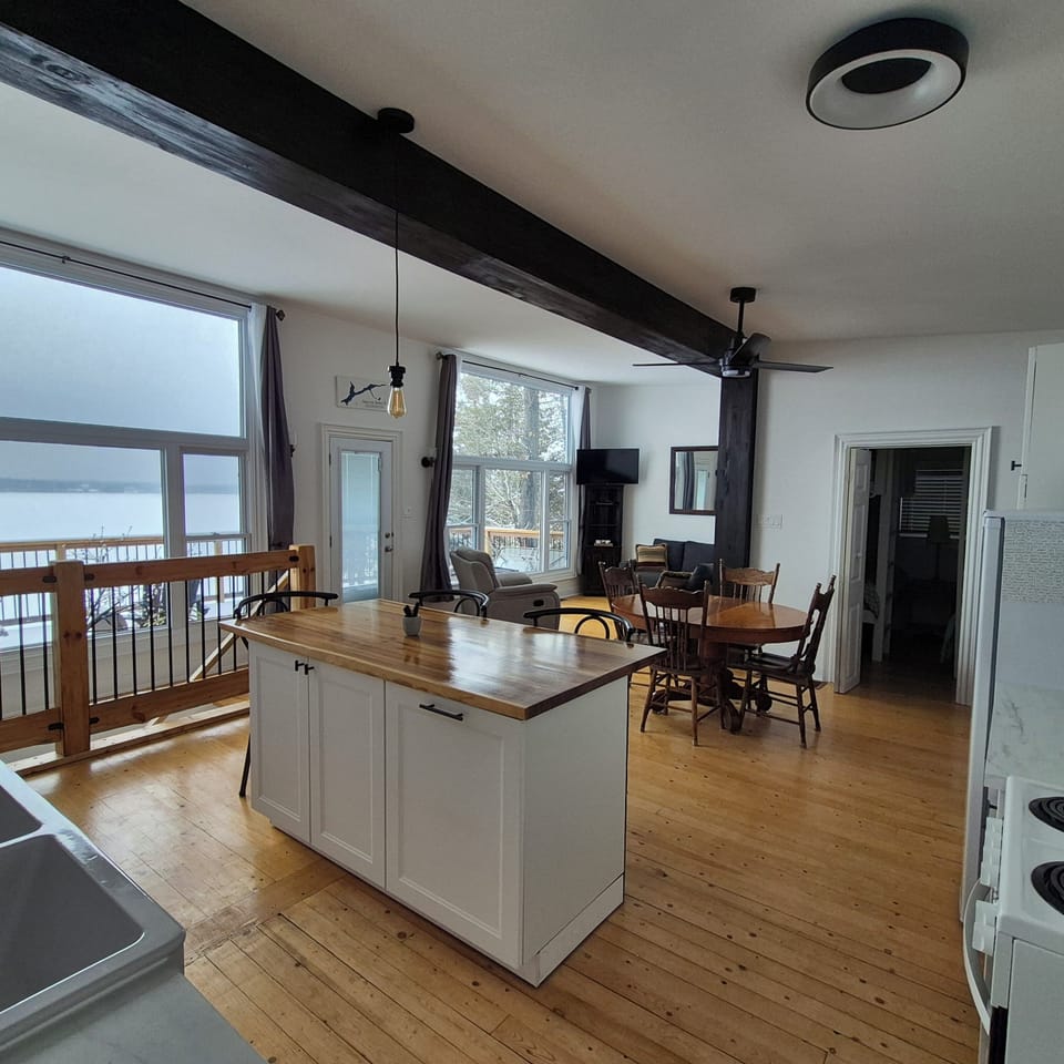 Kitchen and dining area with extendable table and panoramic view of lake