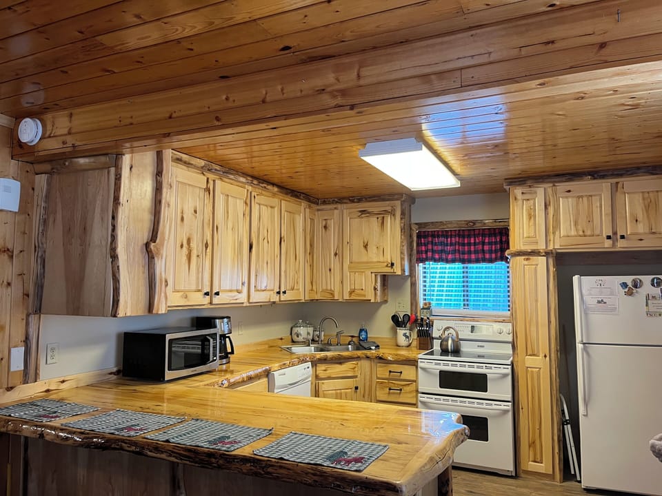 Kitchen bar/island has four adjustable barstools
