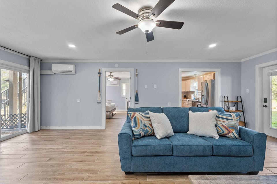 Bright living area with easy access to the dining space and screened patio