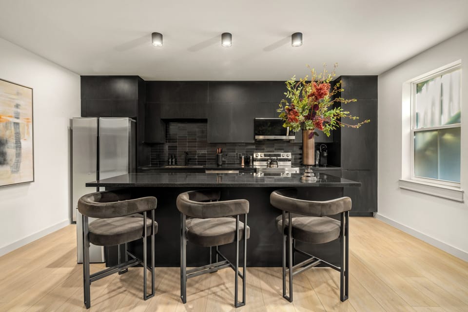 A bold, modern kitchen anchored by sleek bar seating for casual gatherings.
