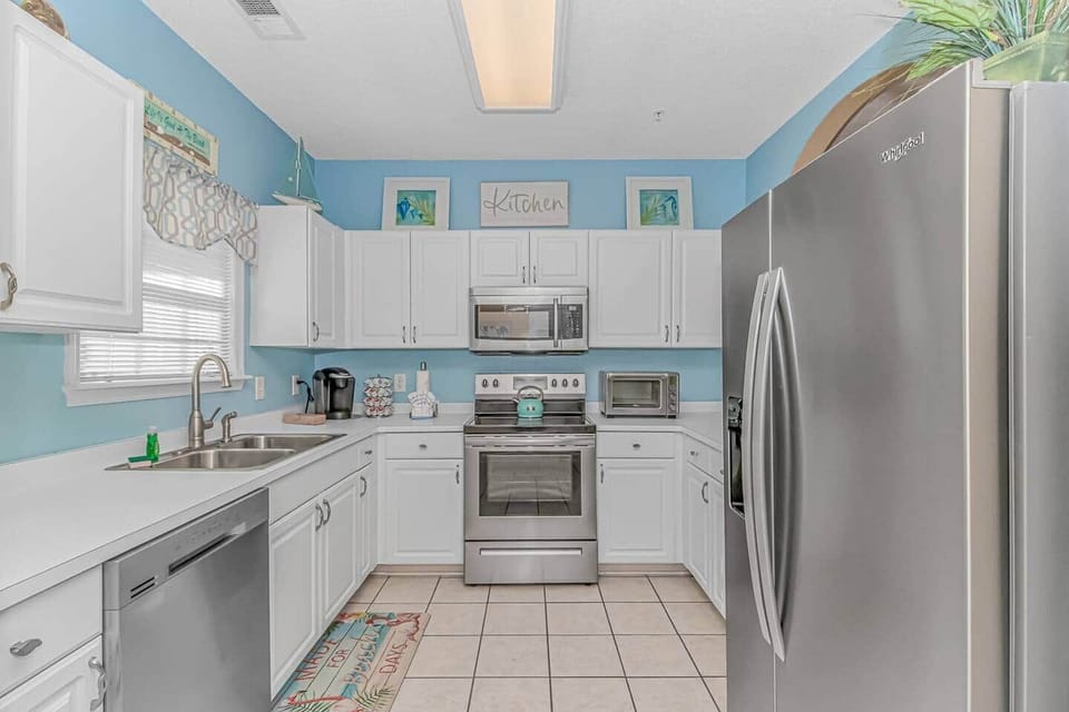 Fully Equipped Coastal Kitchen
Bright, beachy kitchen with stainless appliances, Keurig, toaster oven, and everything you need to cook at home.