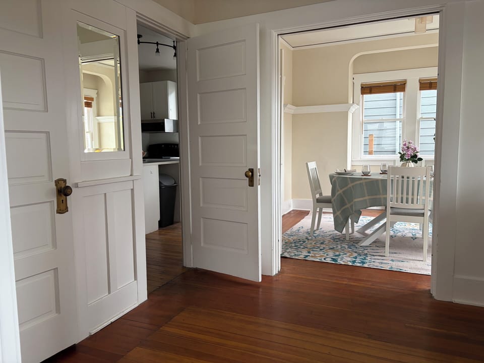 Coat closet, dining room, and kitchen