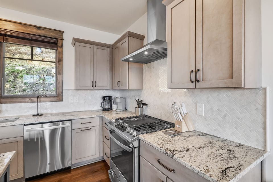 Fully equipped kitchen with coffee maker and modern appliances