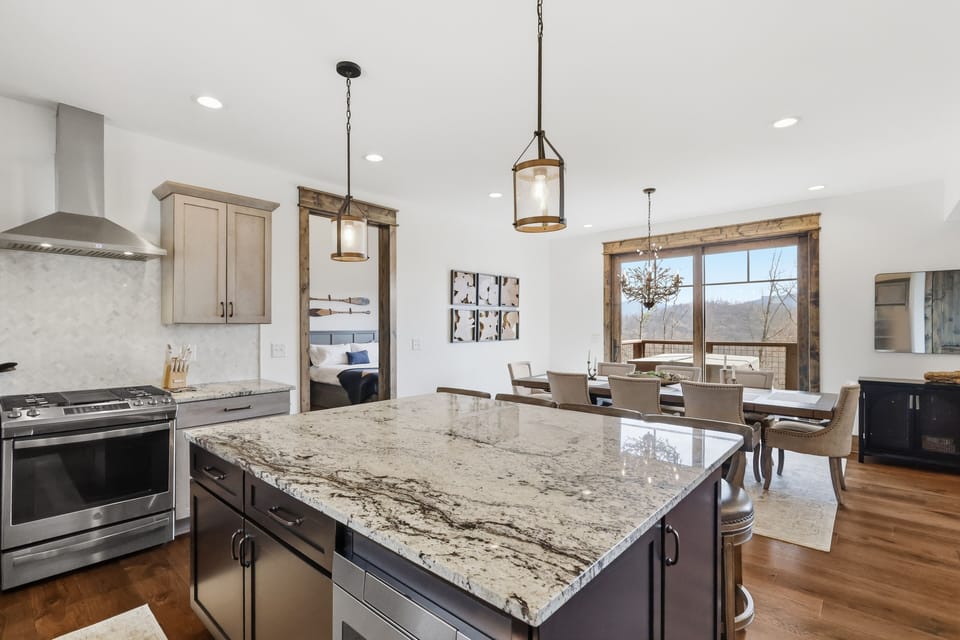 Kitchen opens to the dining area — serve meals with mountain views