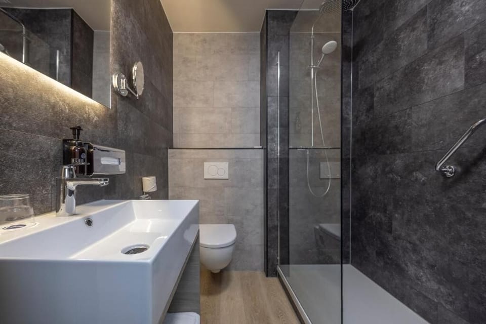 Start your day with bright vanity space and glass shower.