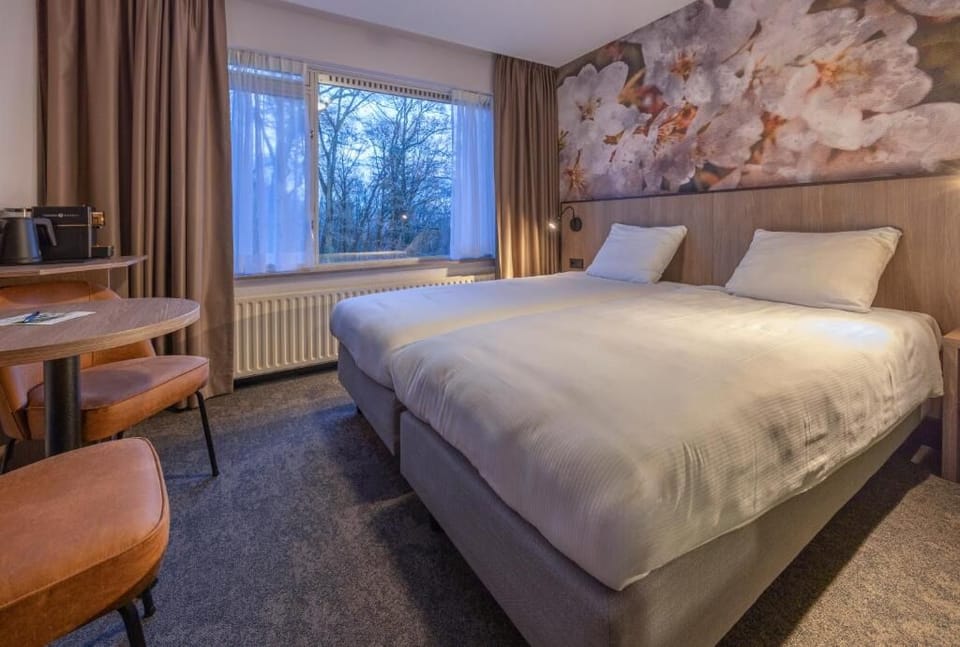Sink into crisp twin beds beside serene woodland views.