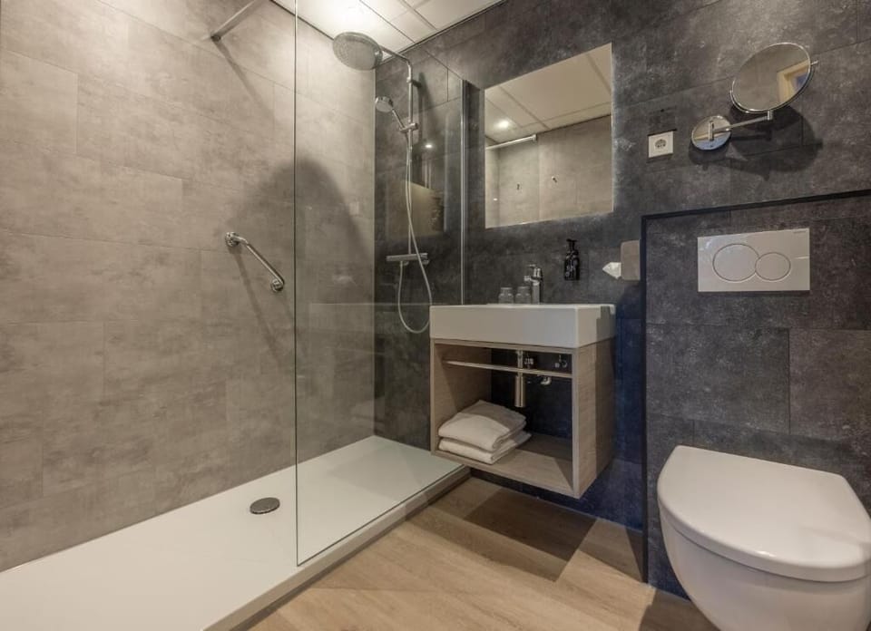 Refresh under a rainfall shower in sleek, modern comfort.