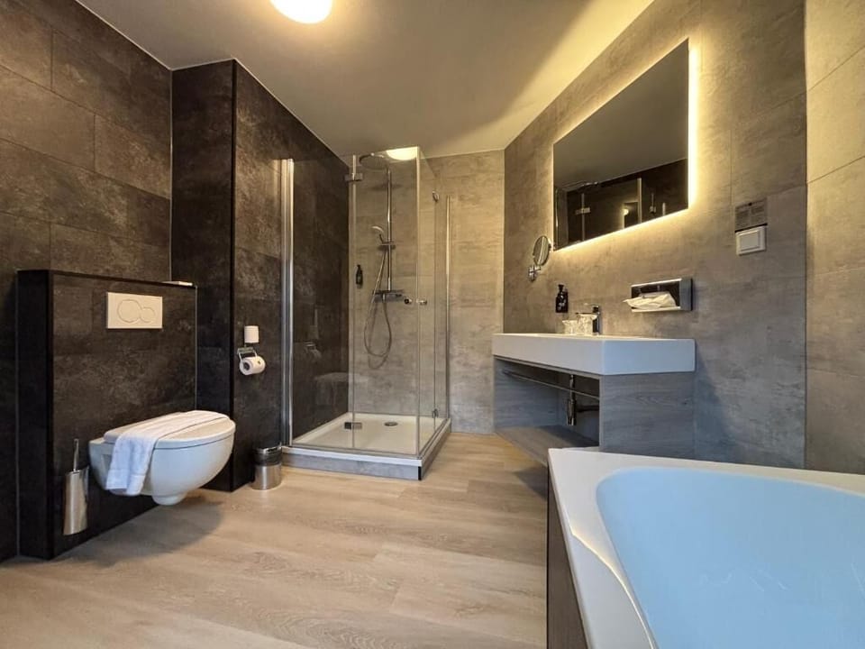Soak and reset in a bright, spa-style bathtub retreat.
