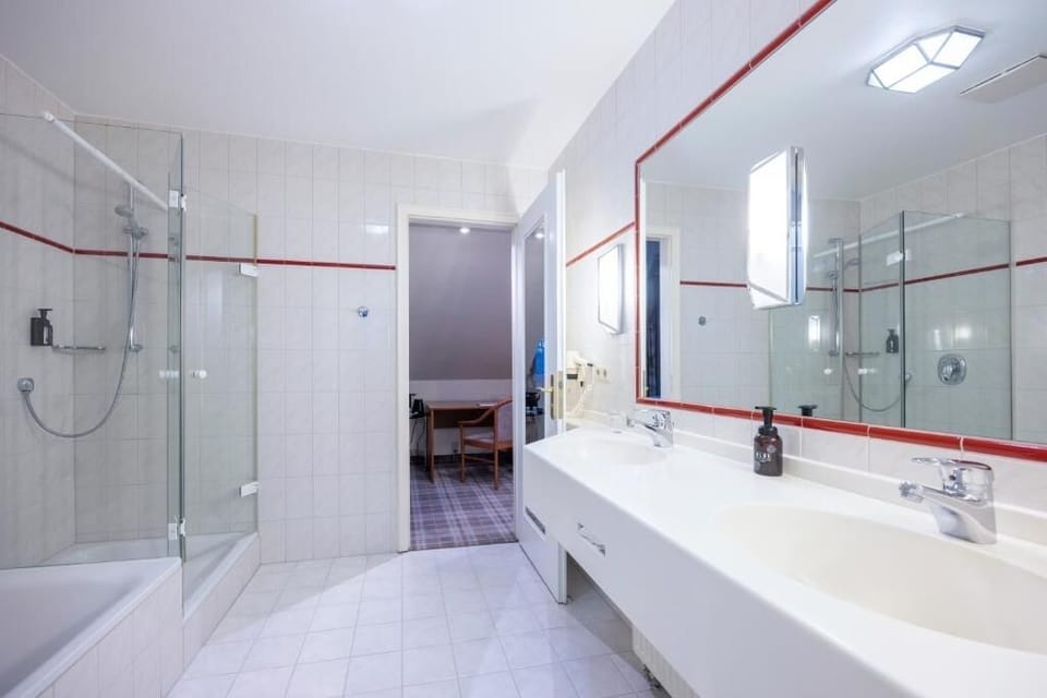 Refresh in the bright bathroom with spacious vanity and shower.