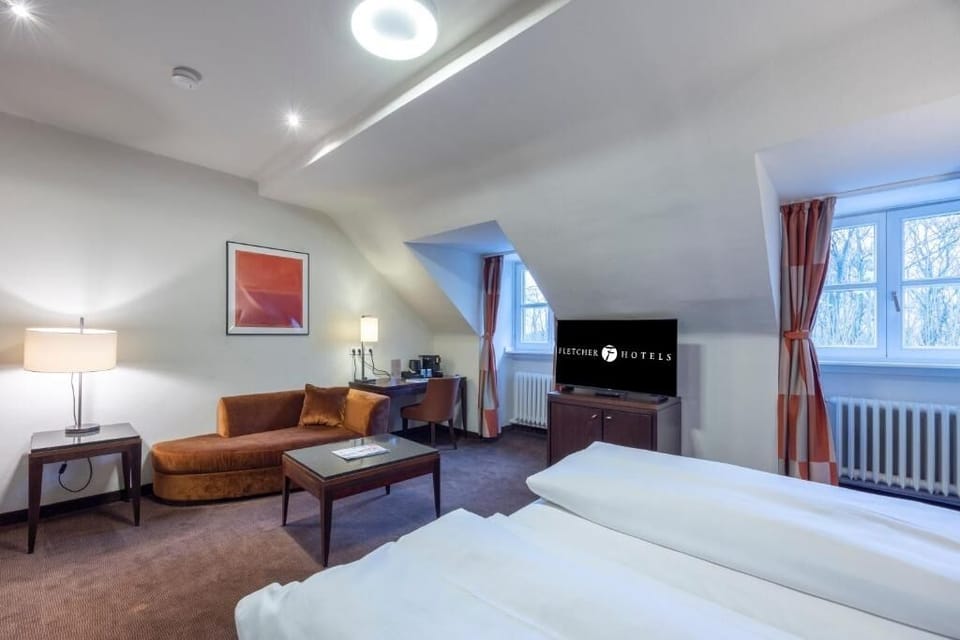 Wake to soft daylight and relax in your private seating corner.