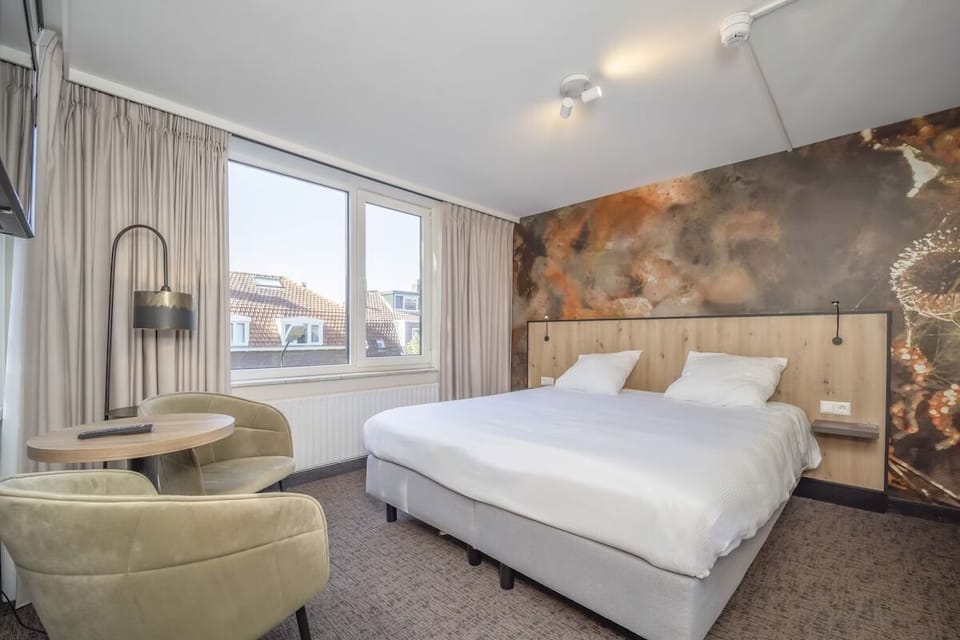 Unwind in a bright king bed with cozy seating corner.