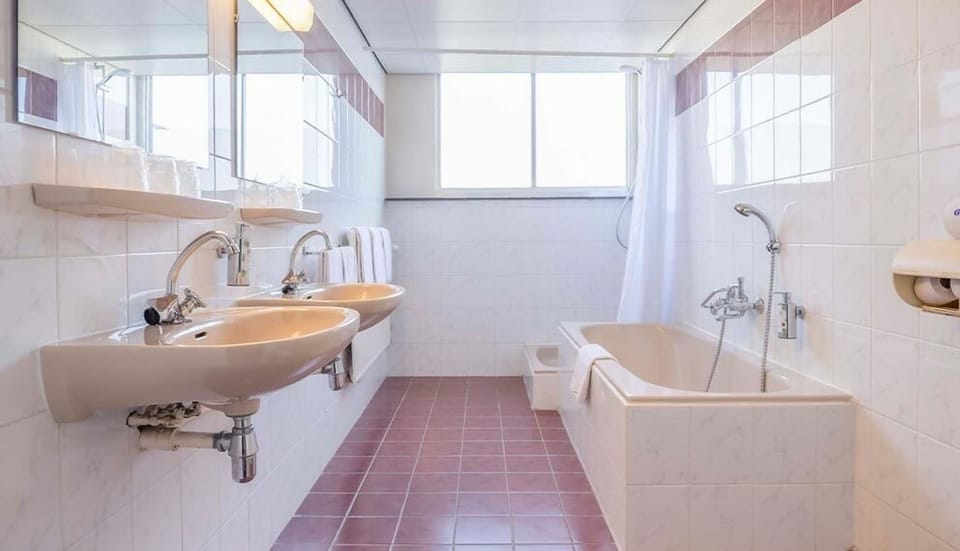 Refresh easily with a bright bath and double sinks.