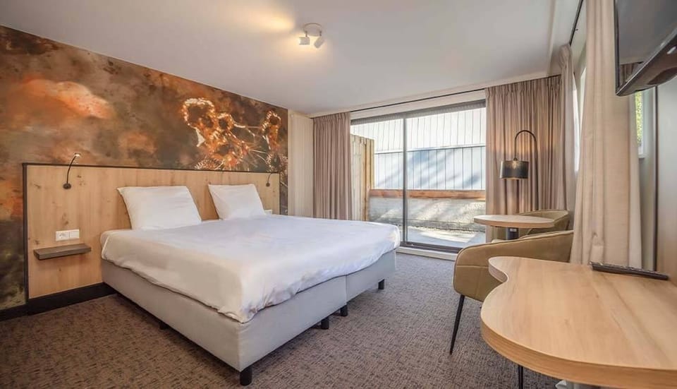 Unwind in a serene bedroom with cozy seating and daylight.
