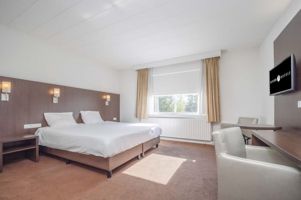 Unwind in a bright, spacious room with plush bedding.