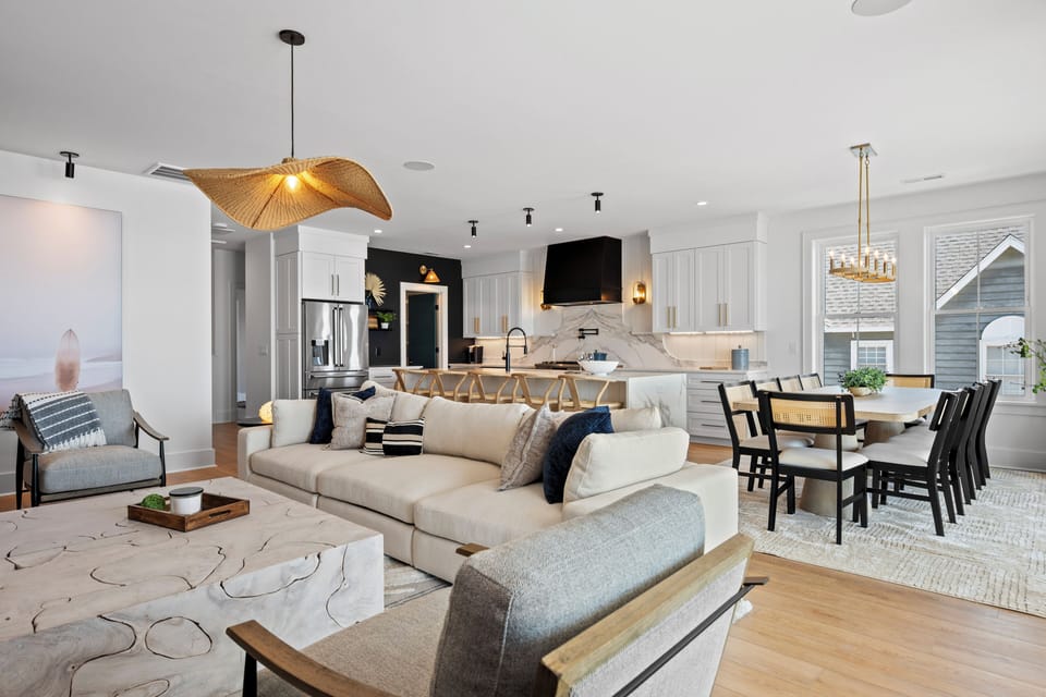 Step into your stylish open-concept retreat where modern comfort meets coastal elegance. Relax on plush seating while your group gathers around the kitchen island.