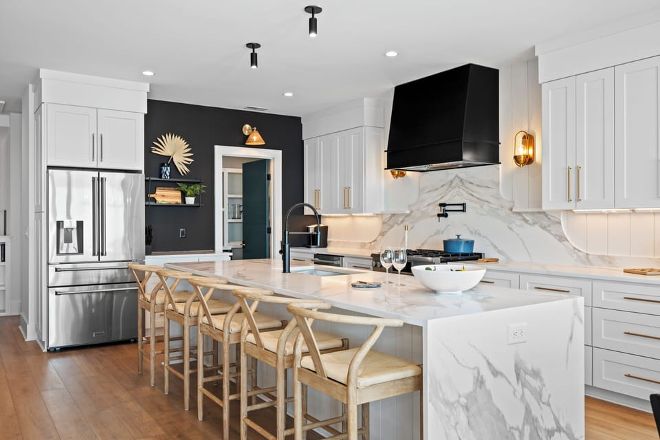 Cook like a chef in this stunning marble kitchen with modern appliances and spacious island seating.